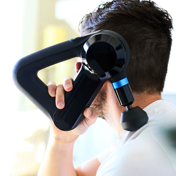 Lifestyle image: Closeup of a person useing a Theragun massager on their neck