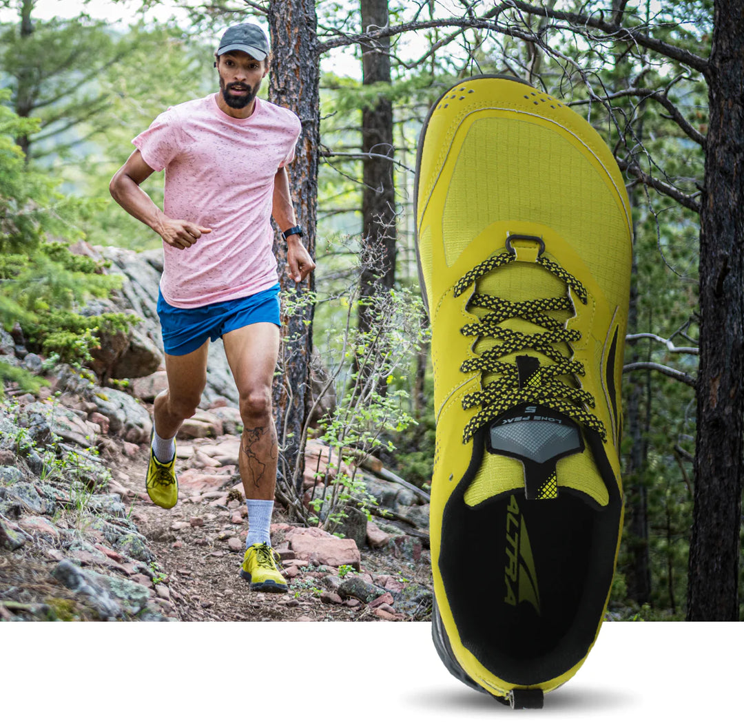 man hiking with yellow shoes