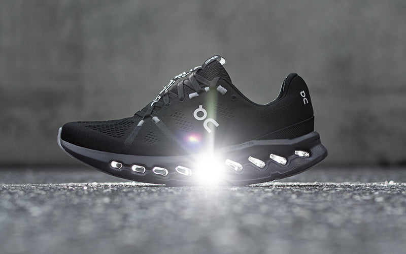 light shining through the midsole clouds of a on cloud running shoe